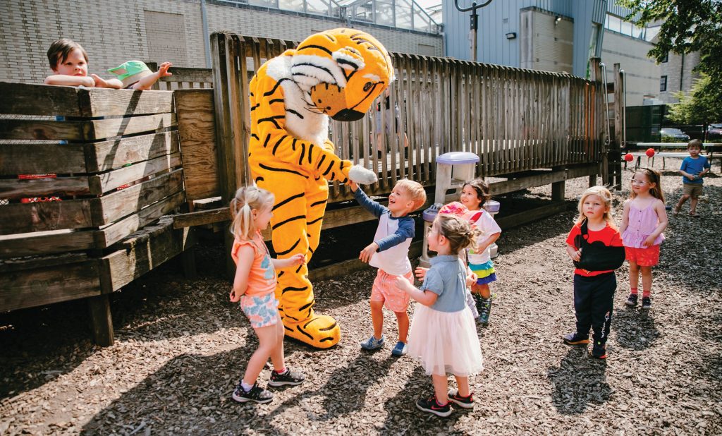Mizzou's mascot Truman the Tiger plays with young children outside on the playground of the Child Development Lab prior to being remodeled in 2025.