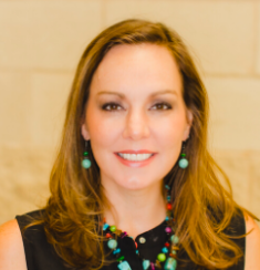 A woman with long blond haie wearing a black shirt.